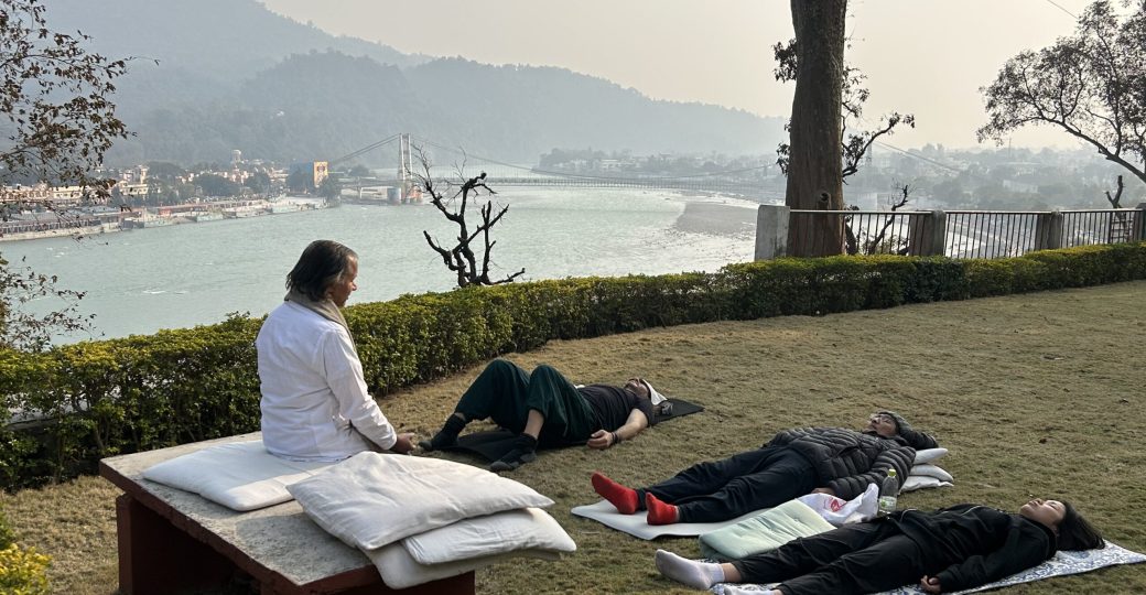 Yoga students practicing meditation at Yoga Niketan Ashram on the banks of the holy Ganga.